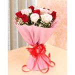"Beautiful 3 Red Roses and 3 White Roses in a pink paper packing with a red ribbon bow from JuneFlowers.com"