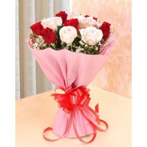 "Beautiful 3 Red Roses and 3 White Roses in a pink paper packing with a red ribbon bow from JuneFlowers.com"