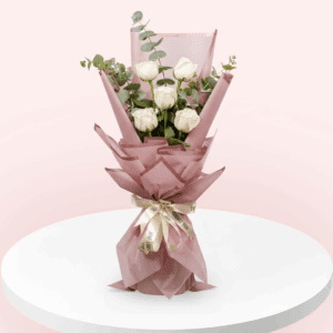 "A bouquet of 5 white roses with eucalyptus and wrapped in a pink Korean paper.