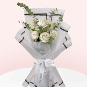 A bouquet of 6 white roses paired with green eucalyptus and wrapped in a white paper