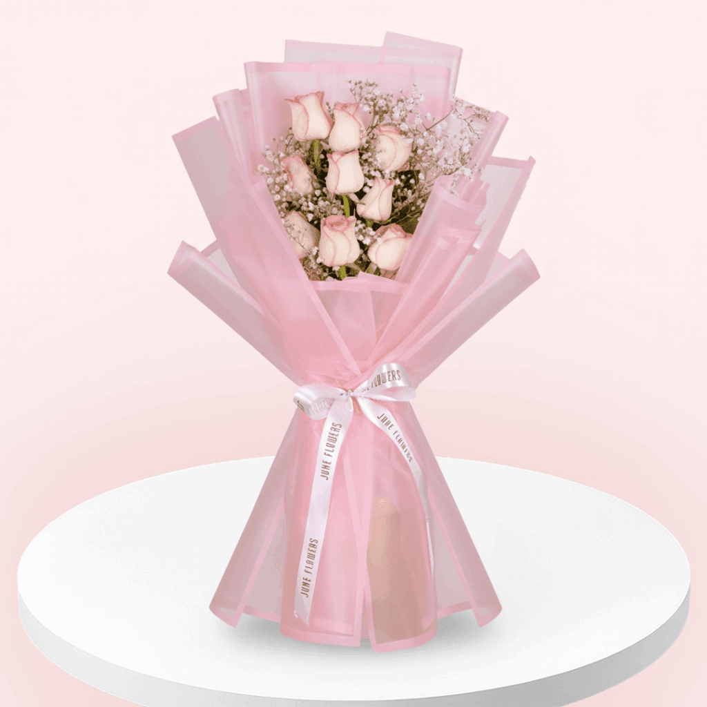 Enjoy this hand-tied 8 pink rose and gypso bouquet wrapped in Korean style flower wrapping sheets with white ribbon