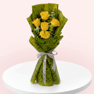 A bouquet of 5 Yellow roses and eucalyptus wrapped in green paper