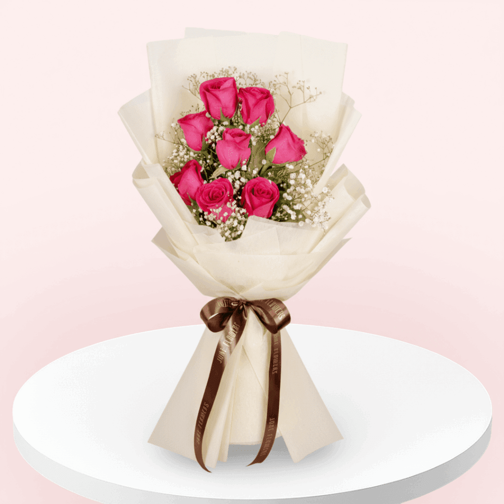 Bouquet of 8 Dark Pink roses and gypso in non-woven pastel cream colour paper wrap with ribbon