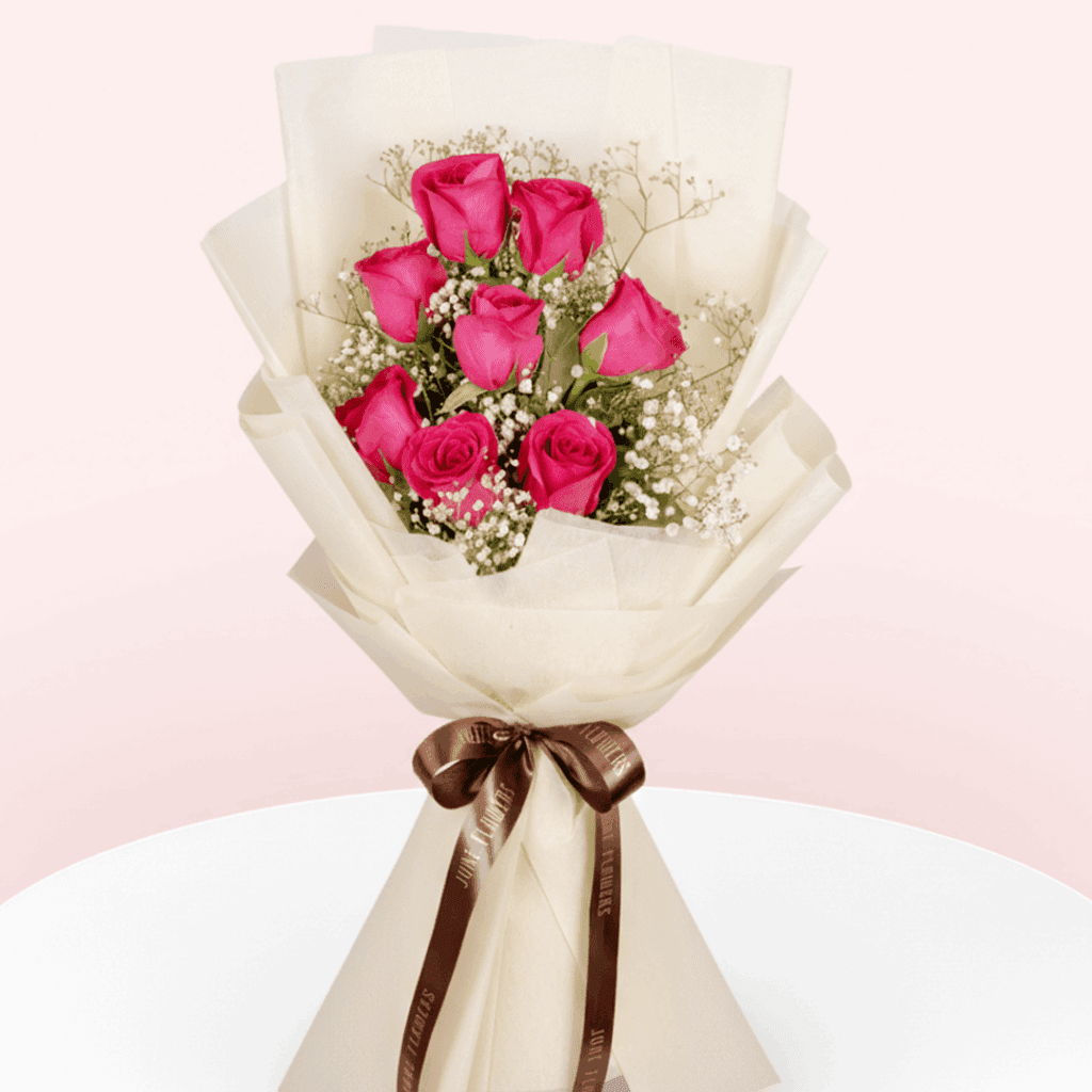 Bouquet of 8 Dark Pink roses and gypso in non-woven pastel cream colour paper wrap with ribbon