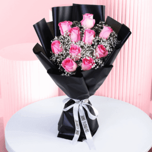 Romantic bouquet with pink roses in black wrap