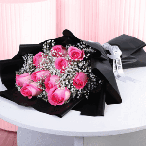 Romantic bouquet with pink roses in black wrap