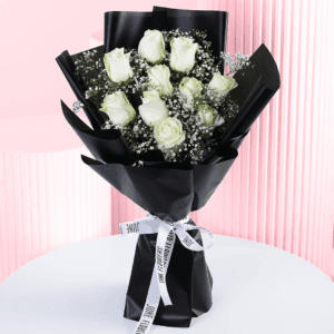 Serene black wrapped white rose bouquet handtied with a white ribbon