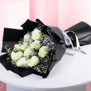 Serene black wrapped white rose bouquet handtied with a white ribbon