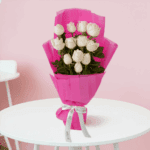 Elegant 12 White Roses Bouquet with green leaves wrapped in white non-woven paper.