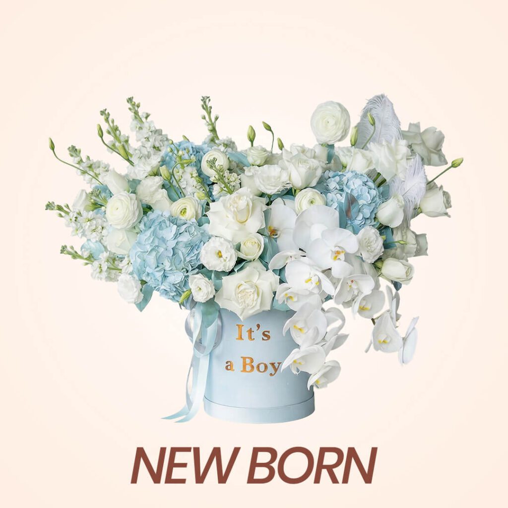 Blue and flowers arrangement in blue box for the new born gesture