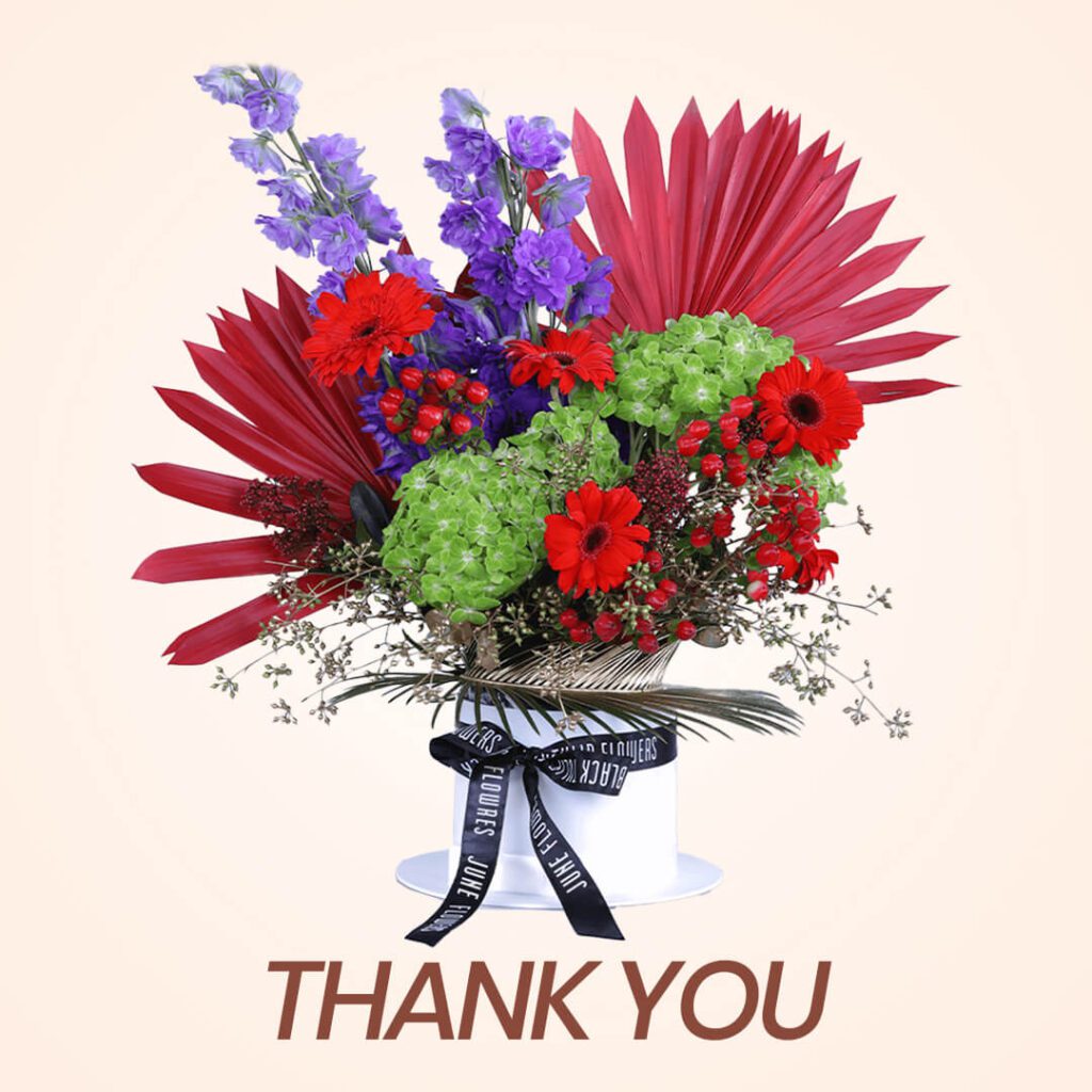 Vibrant mix of colors flower arrangement in white box for the Thank you gesture