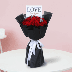A bouquet of red roses with eucalyptus in a Korean-style black luxury wrap, finished with a “Love for You” message card.