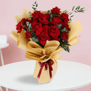 Red roses bouquet with green fillers in a luxury gold wrap, finished with a maroon ribbon.