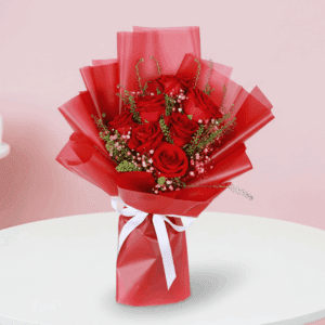 Red roses with delicate white fillers in a red wrap, finished with an “I Love You” message topper.