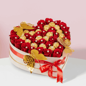 Romantic Valentine flower and chocolate combo featuring red roses and Ferrero Rocher in white heart box.