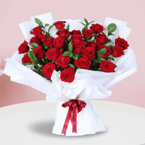 Bouquet of fresh red roses in an elegant white wrap, finished with a “Miss You” message card.