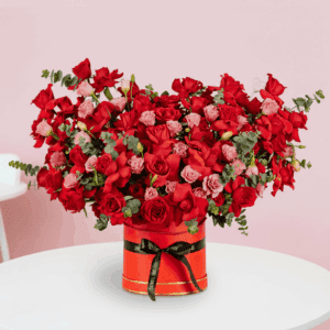 Valentine’s Day flower box with red roses, eustoma and eucalyptus arranged in a premium red round box.