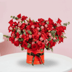 Valentine’s Day flower box with red roses, eustoma and eucalyptus arranged in a premium red round box.