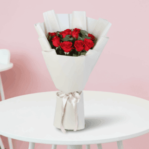 Fresh red roses bouquet wrapped in elegant white non woven paper with white ribbon for Valentine’s Day gifting.
