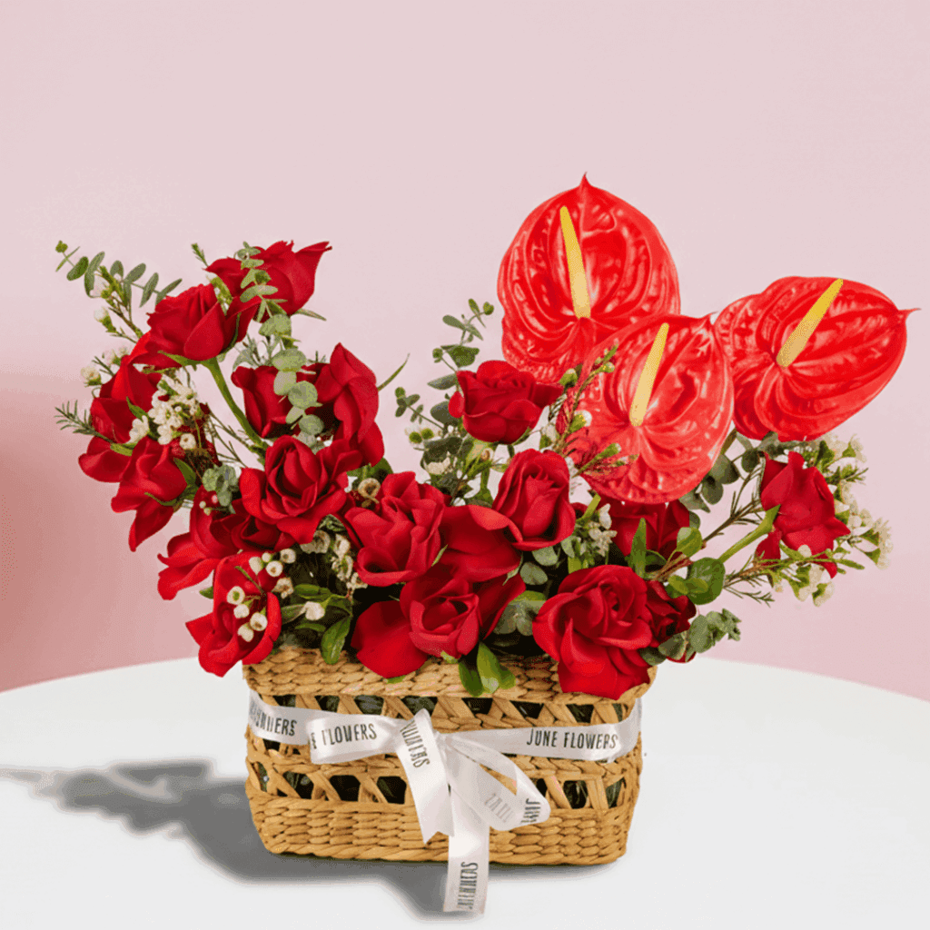 Premium Valentine red rose basket arrangement with anthurium and wax flowers.